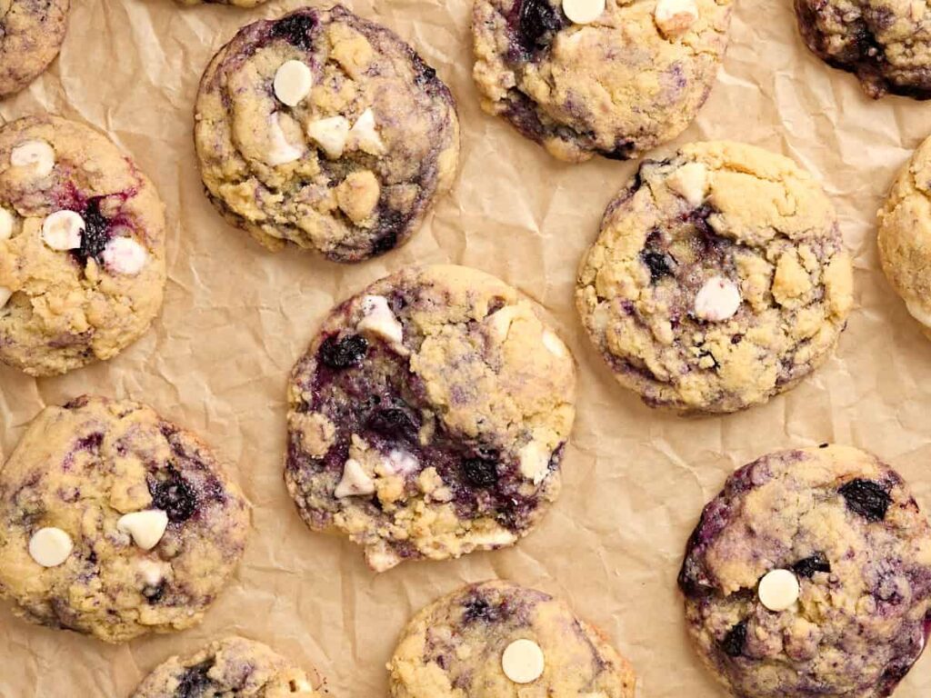 Overhead close up view of blueberry cookies on parchment paper.